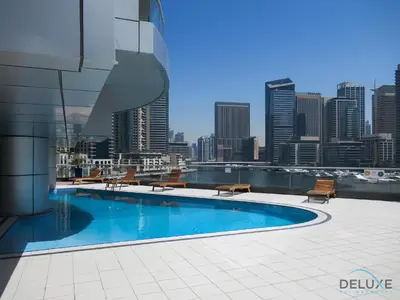 a swimming pool on top of a building with a city skyline at Charming 1BR in The Point Tower, Dubai Marina by Deluxe Holiday Homes in Dubai