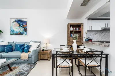 a living room with a couch and a table at Charming 1BR in The Point Tower, Dubai Marina by Deluxe Holiday Homes in Dubai