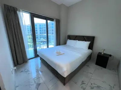 a bedroom with a large bed and a large window at Mag 510: 2-Bedroom Elegance in Dubai