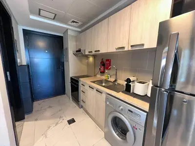 a kitchen with a stainless steel refrigerator and a dishwasher at Mag 510: 2-Bedroom Elegance in Dubai