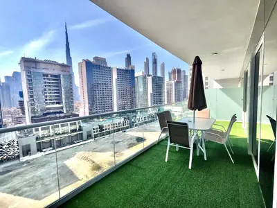a dining room with a view of the city at Lux BnB I Vera Residences I Burj Views in Dubai