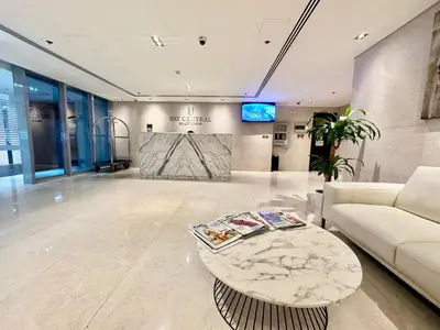 a living room with a couch and a table at Wonderful 1BR Apt with Marina view in Dubai