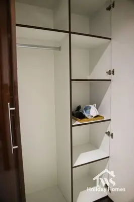 a glass cabinet with shelves in a room at The Urban Oasis - Harmony in Dubai