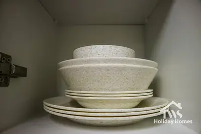 a stack of white bowls sitting on a shelf at The Urban Oasis - Harmony in Dubai