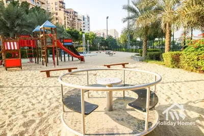a playground with a table and a slide at The Urban Oasis - Harmony in Dubai
