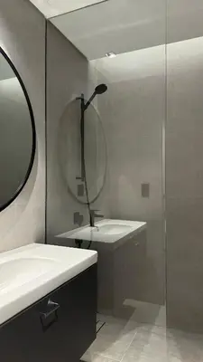 a bathroom with a shower and a sink and a mirror at Exclusive Canal Waterfront Views 15 Northside in Dubai