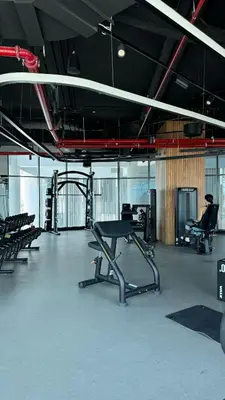 a gym with a table and chairs in a room at Exclusive Canal Waterfront Views 15 Northside in Dubai