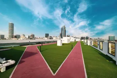 a view from the roof of a building with grass at Large 1BR in JVC Sleeps 4 Rooftop, Pool & Gym in Dubai