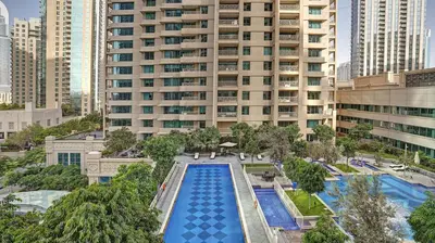 an overhead view of a large building with a swimming pool at 29Boulevard - Modern 2BHK by Radiance Vacation Stays in Dubai