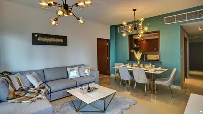 a living room with a couch and a table at 29Boulevard - Modern 2BHK by Radiance Vacation Stays in Dubai