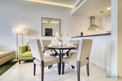a dining room with a table and chairs at Urban 1BR at DAMAC Celestia B Dubai South by Deluxe Holiday Homes in Dubai