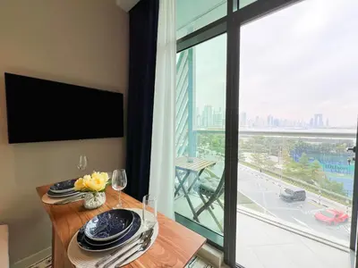 a dining room with a table and a large window at Luxurious Sea-View Studio in Seven Palm - 20AB8 in Dubai