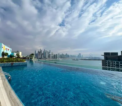 a large swimming pool on top of a building with a city at Luxurious Sea-View Studio in Seven Palm - 20AB8 in Dubai