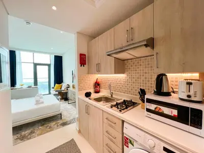 a kitchen with a sink and a stove top oven at Luxurious Sea-View Studio in Seven Palm - 20AB8 in Dubai