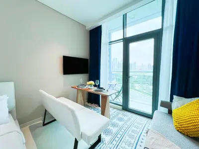 a hotel room with a desk and a white chair at Luxurious Sea-View Studio in Seven Palm - 20AB8 in Dubai