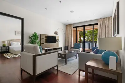 a living room with a couch and a table at StoneTree - Luxury 2 BR - Beach Access in Dubai