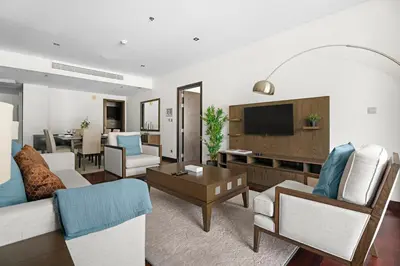 a living room with a couch and a tv at StoneTree - Luxury 2 BR - Beach Access in Dubai