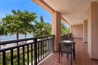 a balcony with a table and chairs and a view of the beach at StoneTree - Luxury 2 BR - Beach Access in Dubai