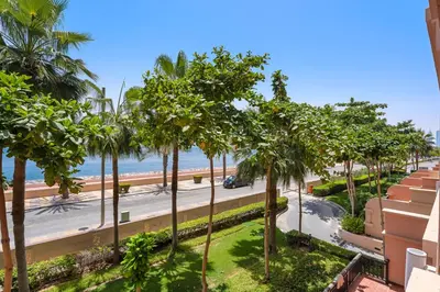 a view of a street with palm trees and the ocean at StoneTree - Luxury 2 BR - Beach Access in Dubai