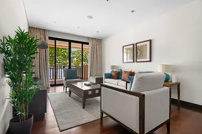 a living room with a couch and a table at StoneTree - Luxury 2 BR - Beach Access in Dubai
