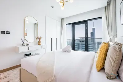 a white bedroom with a large bed and a large window at Delightful 2BR Apartment in VIDA Residences Dubai Marina by Deluxe Holiday Homes in Dubai
