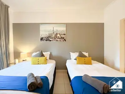 two beds sitting next to each other in a room at Luxury 2Bedroom with Terrace & Burj Khalifa view in Dubai