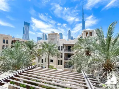 a view of a city with palm trees and buildings at Luxury 2Bedroom with Terrace & Burj Khalifa view in Dubai
