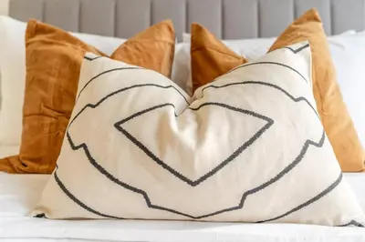 a pillow with a heart pattern on a couch at Guest Favourite! Beautiful 1 bedroom apartment in Dubai