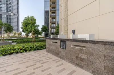 an outdoor bar in a city with tall buildings at Guest Favourite! Beautiful 1 bedroom apartment in Dubai