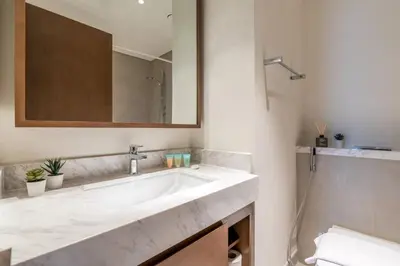 a bathroom with a white sink and a mirror at Guest Favourite! Beautiful 1 bedroom apartment in Dubai