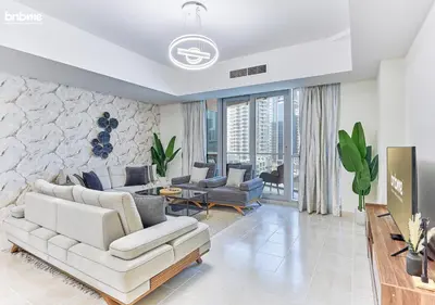 a living room with a couch and a table at bnbmehomes - DAMAC Waves Tower in Dubai