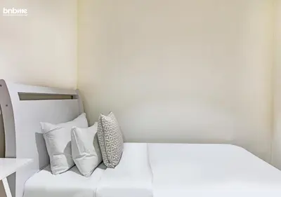 a white couch with pillows in a room at bnbmehomes - DAMAC Waves Tower in Dubai