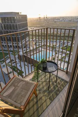 a balcony with a table and a bench and a view at Oraya - Brand New 2BR Apt in Socio Tower at Dubai Hills in Dubai