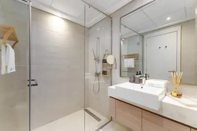 a bathroom with a sink and a shower at Chic 1BR Apartment in Azizi Riviera, Meydan in Dubai