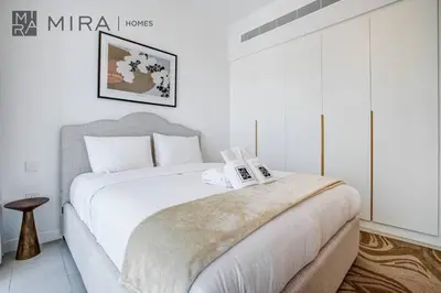 a white bedroom with a large bed in a room at Mira Holiday Homes - Luxury 2 bed apartment in La Vie in Dubai