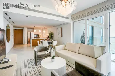 a living room with a couch and a table at Mira Holiday Homes - Luxury 2 bed apartment in La Vie in Dubai