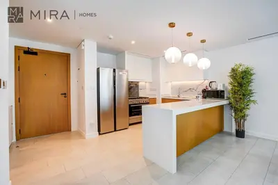 a kitchen with a refrigerator and a counter top at Mira Holiday Homes - Luxury 2 bed apartment in La Vie in Dubai