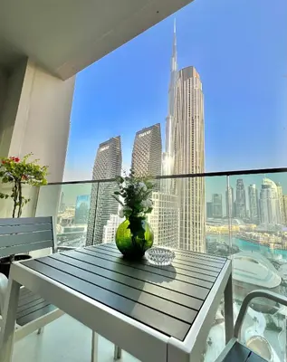 a table with a vase sitting on top of a balcony at VIP Experience Dubai Downtown at Forte Tower - Burj Khalifa and Fountain View - Modern Luxury Apartments in Dubai