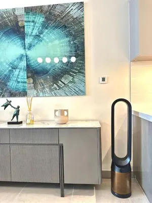 a kitchen with a table with a large painting on the wall at VIP Experience Dubai Downtown at Forte Tower - Burj Khalifa and Fountain View - Modern Luxury Apartments in Dubai