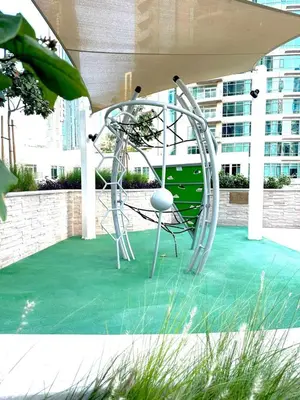 a chair sitting on top of a green floor at VIP Experience Dubai Downtown at Forte Tower - Burj Khalifa and Fountain View - Modern Luxury Apartments in Dubai