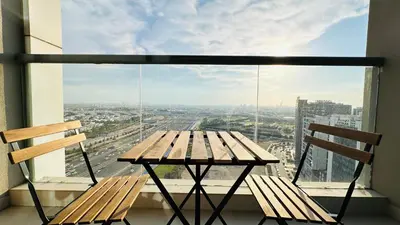 a table and two chairs in front of a window at Oval Tower Furnished Studio Business Bay in Dubai