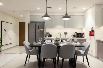 a kitchen with a dining room table and chairs at Forte Tower - Downtown Dream, Ocean View, Opposite Dubai Mall in Dubai