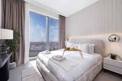 a bedroom with a bed and a large window at Forte Tower - Downtown Dream, Ocean View, Opposite Dubai Mall in Dubai