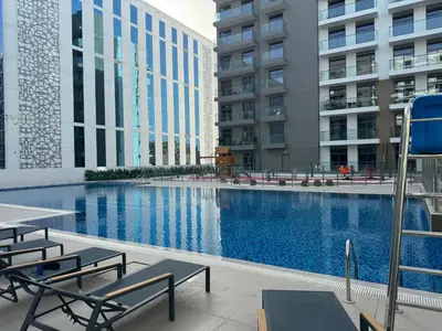 a swimming pool in the middle of a building at ASHRI HH, STANDARD STUDIO IN STUDIO CITY in Dubai