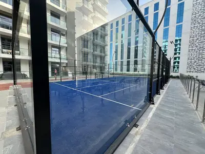 a tennis court in the middle of a building at ASHRI HH, STANDARD STUDIO IN STUDIO CITY in Dubai