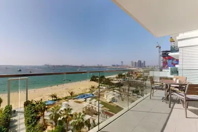 a balcony with a view of a beach and the ocean at La Vie JBR - Breathtaking Two Bedroom in Dubai