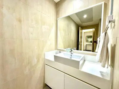 a bathroom with a white sink and a mirror at 1BR Apartment, Full Sea and JBR View in Dubai