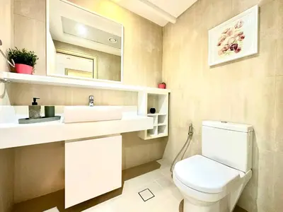 a bathroom with a toilet and a sink and a mirror at 1BR Apartment, Full Sea and JBR View in Dubai