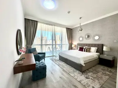 a bedroom with a bed and a chair and a window at 1BR Apartment, Full Sea and JBR View in Dubai