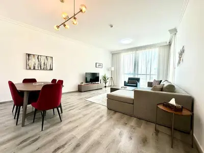 a living room with a bed and a table and chairs at 1BR Apartment, Full Sea and JBR View in Dubai